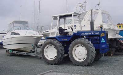 Tractor towing boat at Lleyn Marine Park and Launch facility